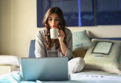 woman in grey jacket sits on bed uses grey laptop byemuch Privacy Policy